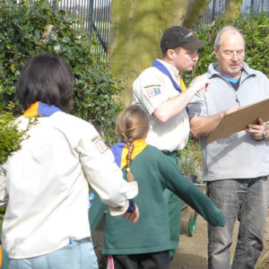 Friends volunteer discussing plans with Cubs for the Cubs Remembrance Garden.