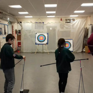 Cubs try their hand at archery.