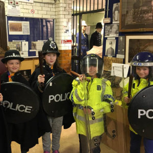 Cubs trying on Police uniforms at the Warrington Police Museum - 2018.