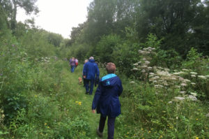 Walkers enjoying a stroll through Rixton Claypits Nature Reserve - a Site of Special Scientific Interest (SSSI)